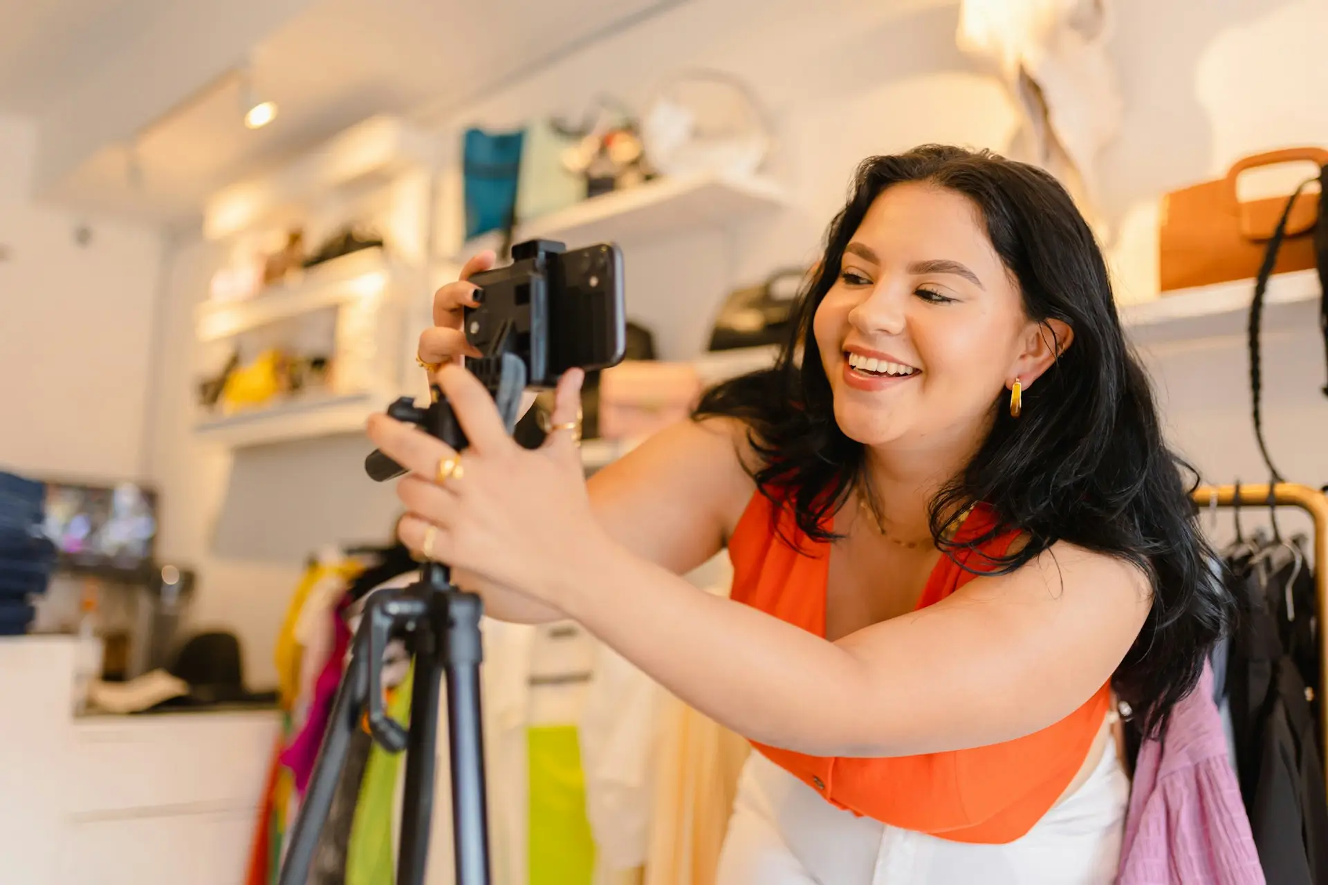 Woman filming with smartphone on tripod in store