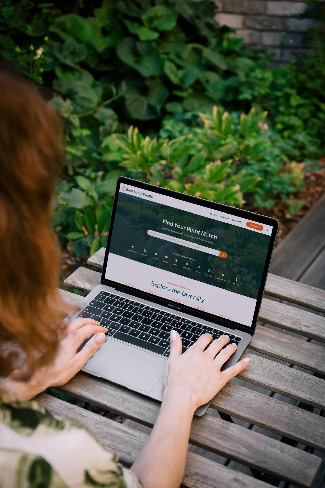 Person browsing plant website on a laptop