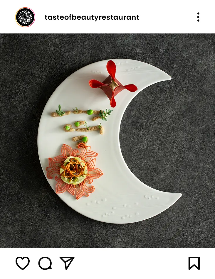 Elegant gourmet dish on crescent-shaped plate