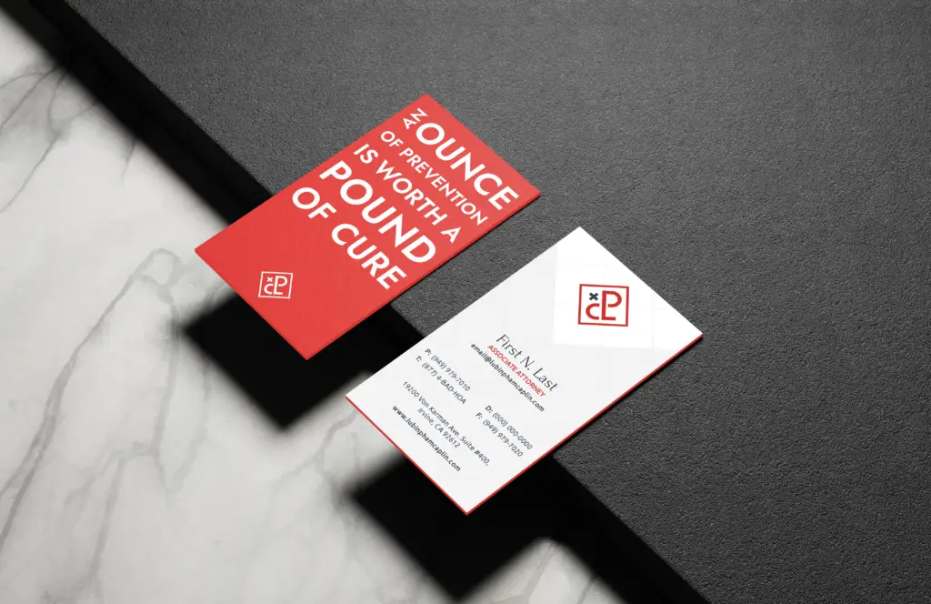 Red prevention quote business cards on black surface.