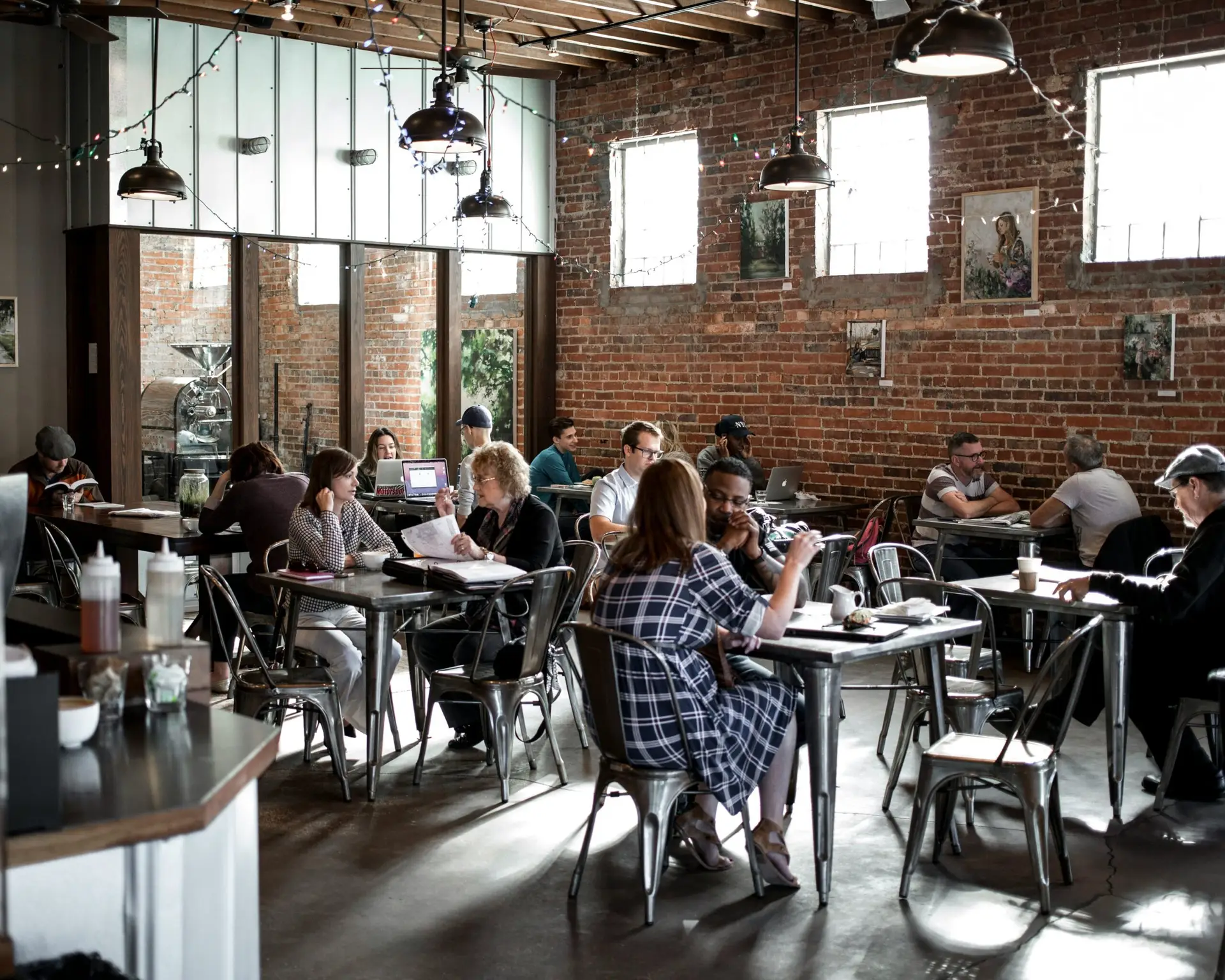 People working in a cozy, rustic coffee shop.