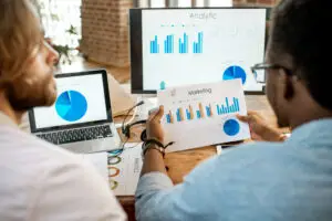 Team analyzes marketing data with charts displayed.