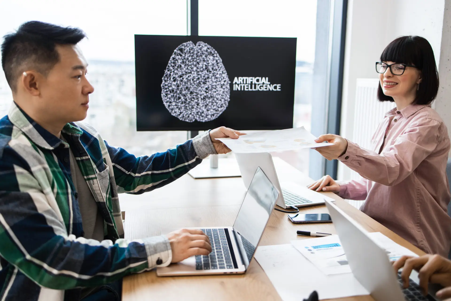 Colleagues discussing artificial intelligence project in office.