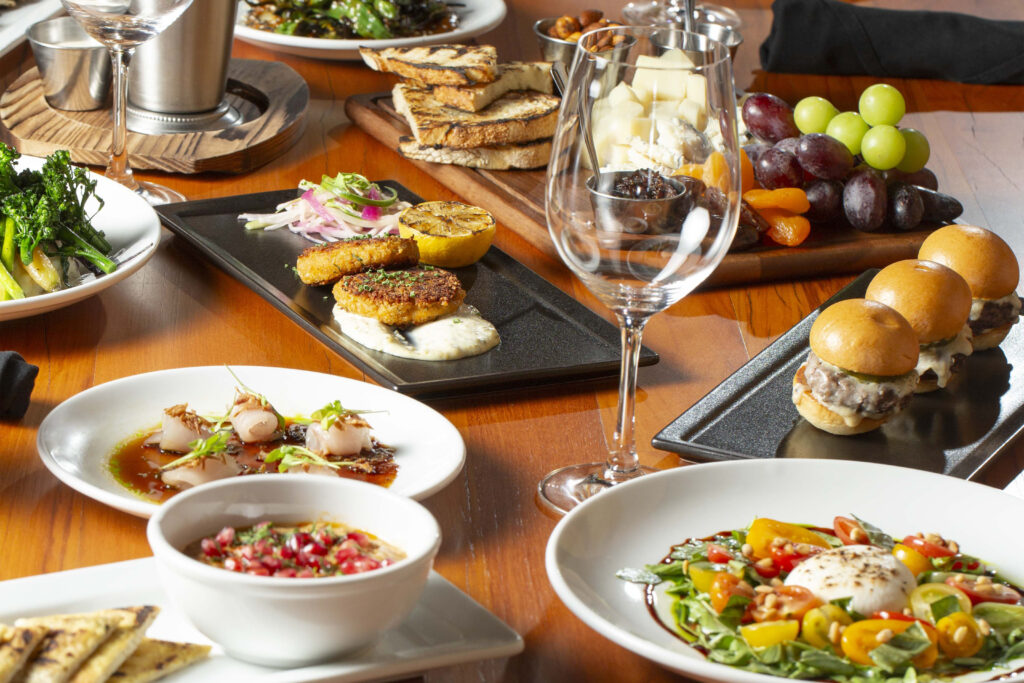 Variety of gourmet dishes on a dining table.