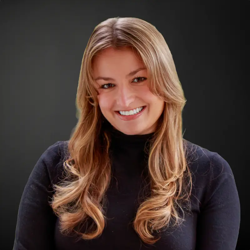 Smiling woman with long hair, black top.