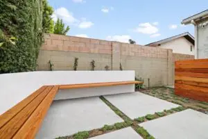 Modern backyard patio with wooden bench seating