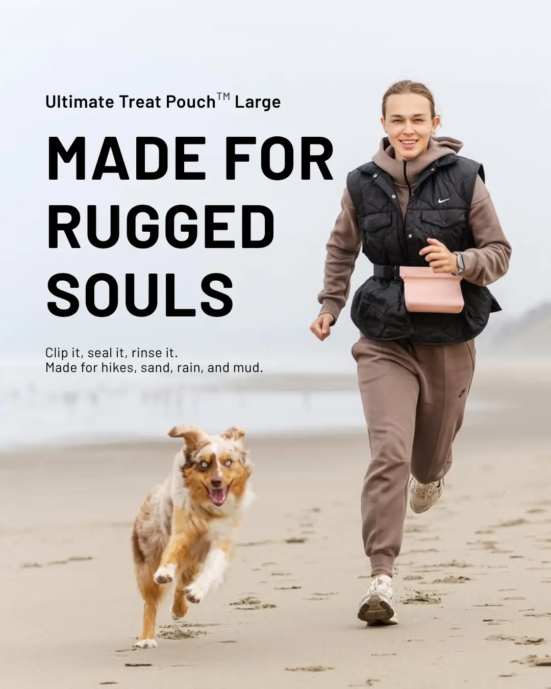 Woman running on beach with dog and treat pouch