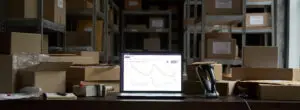 Laptop showing inventory data in warehouse