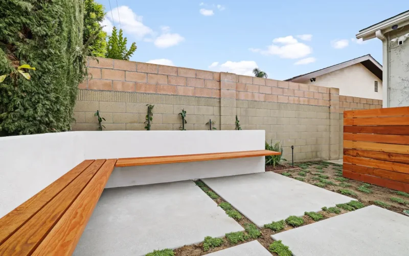 Modern backyard patio with wooden bench seating
