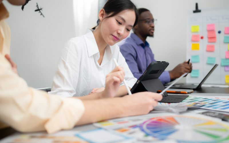 multiethnic team of architects and designers are meeting to brai Designers collaborating on color palette project