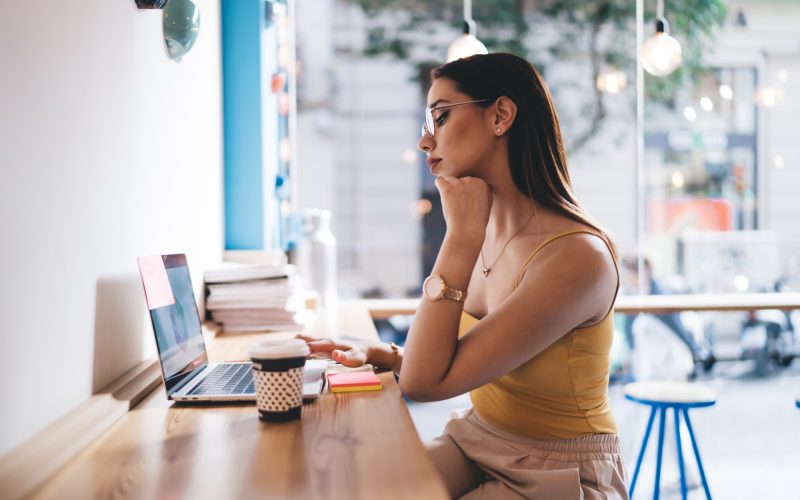 Skilled hipster girl connecting to public 4g wireless internet for browsing social media